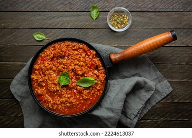 Overhead View Of Red Meat Sauce In Skillet Pan On Textile Rustic