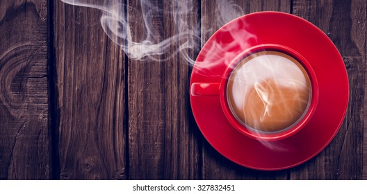 Overhead View Of Red Tea Cup Against Wooden Table