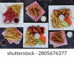 Overhead view of a restaurant appetizer sampler featuring chicken wings, mozzarella sticks, jalapeño poppers, seasoned fries, and dipping sauces on serving platters.