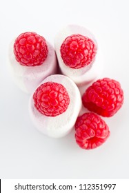 Overhead View Of Ripe Red Raspberries On Top Of Spongy White Marshmallow Ready For Dessert