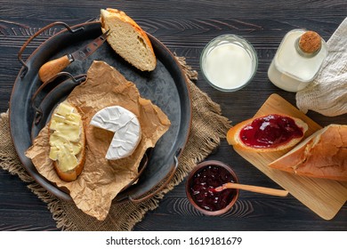 Overhead View Of Rustic Country Breakfast With Brie Cheese, Milk, Baguette And Cranberry Jam