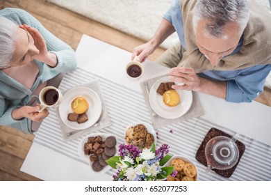 Overhead View Of Senior Couple Having Breakfast At Home
