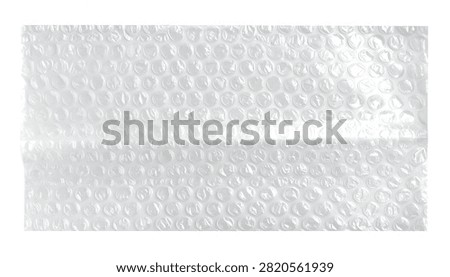 Overhead view showcasing the texture of clear bubble wrap highlighting its small and large air-filled pockets against a clean white backdrop.