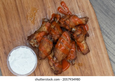 Overhead View Of Side Dish Of Drizzled Buffalo Chicken Wings Are The Perfect Appetizer For A Hearty Meal To Eat.