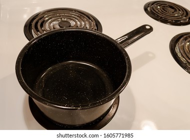 Overhead View Of A Single Vintage Pot On A White Electric Stove.