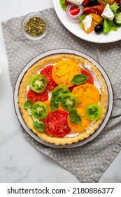 Overhead View Of Sliced Heirloom Tomato Ricotta Quiche On Plate 