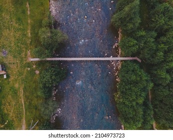 Overhead View Of Small Bridge Across Mountain River Copy Space