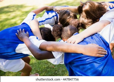 Overhead View Of Soccer Team Forming Huddle In The Park