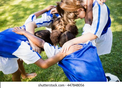 Overhead View Of Soccer Team Forming Huddle In The Park