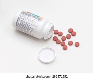 Overhead View Of Spilled Bottle Of Ibuprofen Pills On A White Background