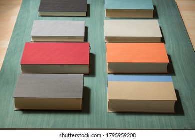 Overhead View Of A Stack Of Different Hardcover Books In A Row With Perspective.