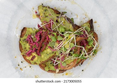Overhead view of super avocado toast topped with watercress will start any day with a nutrional boost.