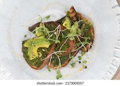 Overhead view of super Pesto toast topped with watercress will start any day with a nutrional boost.