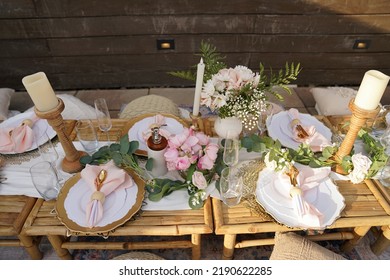 An overhead view of a table that is set up for a fancy picnic on top of a residential rooftop