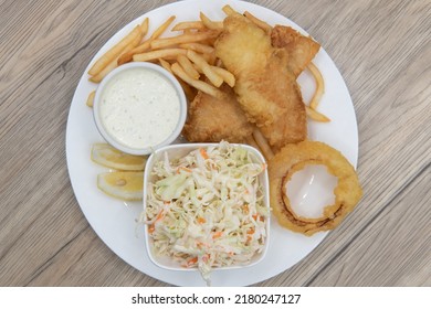 Overhead View Of Tempting Deep Fried Meal Consisting Of Shrimp, Fish, French Fries, And Cole Slaw Will Ensure That The Belly Will Be Full.