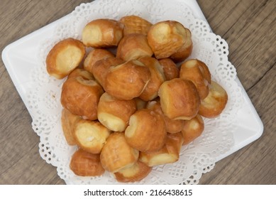 Overhead View Of Tempting Fresh From The Oven Glazed Donut Holes From The Bakery Stacked On A Plate.