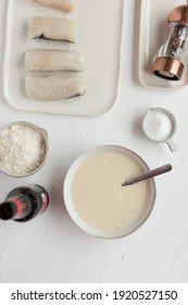 Overhead View Of Tempura Ingredients Next To A Final Tempura Butter Ready To Fry Hake Loins.