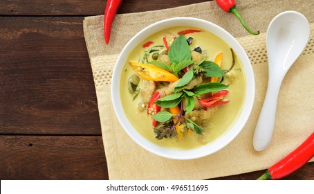 Overhead View Of Thai Green Curry With Fresh Fish Balls In White Bowl On Wooden Background