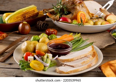 Overhead View Of Thanksgiving Plate Of Roast Turkey With Vegetables On Wooden Background. Thanksgiving, Autumn, Fall, American Tradition And Celebration Concept.