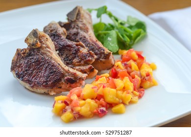 Overhead View Of Thin Lamb Chops With A Colourful Mango Salsa