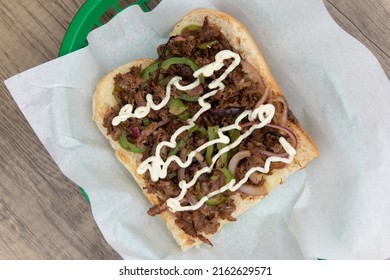 Overhead View Of Tradional Delicious Philly Cheesesteak Sandwich Loaded With All The Favorites And Presented On An Open Face.