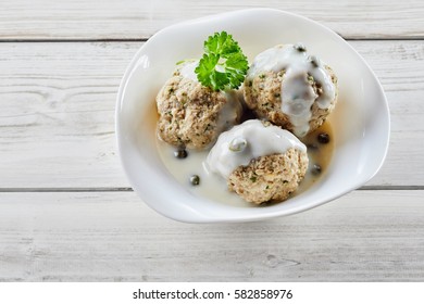 Overhead View Of Traditional German Meatballs Covered In Capers And Creamy White Sauce. In German It Called Königsberger Klopse.