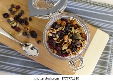 Overhead View Of A Trail Mix In A Glass Jar With Dried Fruits, Nuts, And Seeds