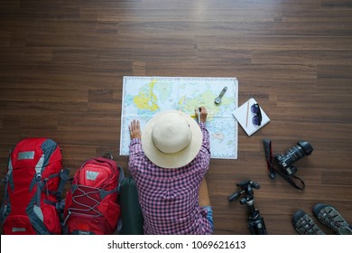 Overhead View Of Traveler Woman Plan And Backpack Planning Vacation Trip With Map. Top View.                   