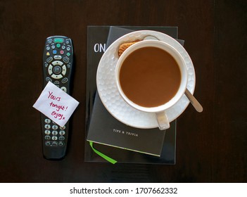 Overhead View Of A TV Remote Control That Has A Simple Handwritten Note On Top Saying 