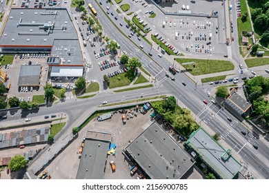 Overhead View Of Urban Crossroad Near Shopping Mall And Parking Lot With Cars