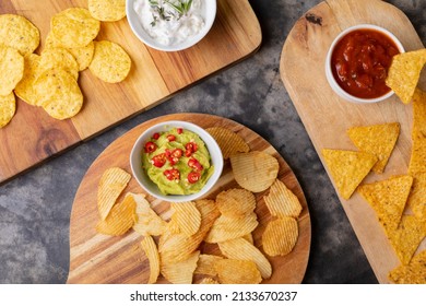 Overhead View Various Chips With Different Salsa Served On Serving Board At Table. Unaltered, Unhealthy Food, Snack, Dipping Sauce, Variation, Crunchy And Savory Food.