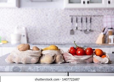 An Overhead View Of Vegetable And Fruits In Net Bag On Kitchen Counter