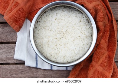 Overhead View Of Vessel With Cooked White Basmati Rice On Wooden Background