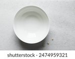 Overhead view of a white ceramic bowl on a marble countertop, Top view of a white ceramic mixing bowl, Flat lay of ceramic batter bowl