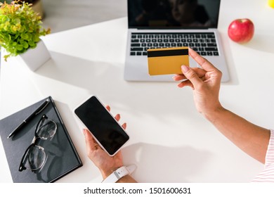 Overhead View Of Woman Holding Credit Card Near Laptop 