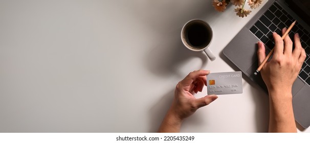 Overhead View Of Woman Holding Credit Card And Making Payment On Internet Via Laptop. Online Shopping, E-commerce Concept