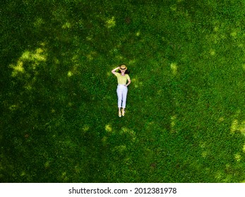 Overhead View Of Woman Laying Down On Green Grass Summertime