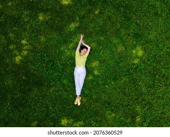 Overhead View Of Woman Laying Down On Green Grass Summertime