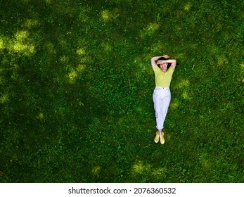 Overhead View Of Woman Laying Down On Green Grass Summertime