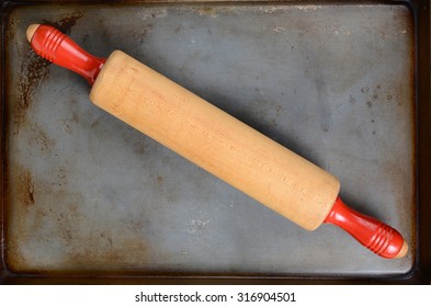 Overhead View Of A Wood Rolling Pin At An Angle On A Baking Sheet. Horizontal Format With Copy Space.