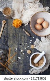 Overhead View Of A Wooden Table With Ingredients  For Preparing A Carrot Cake