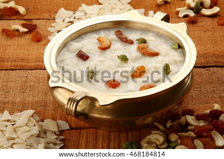 Overhead view--Palada payasam-a delicious  dessert  made with  rice, milk. sugar and dry fruits,South Indian cuisine, served n traditional brass pot,Shallow depth of field photograph. Foto stock © 