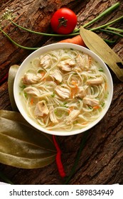 Overhead View-Traditional Chicken Noodle Soup On A Rustic Wood Background.