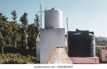 Overhead water tanks on the roofs for storing the water needs for the house. 