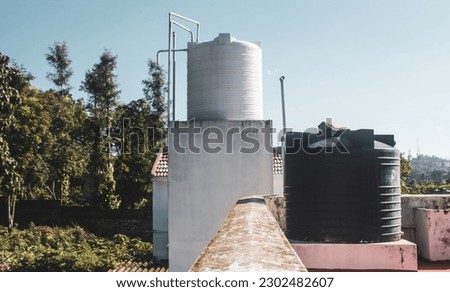 Overhead water tanks on the roofs for storing the water needs for the house. 
