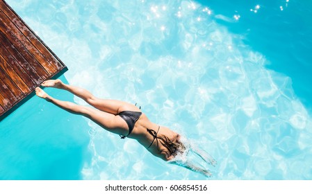 Overhead Of Woman Diving In The Pool