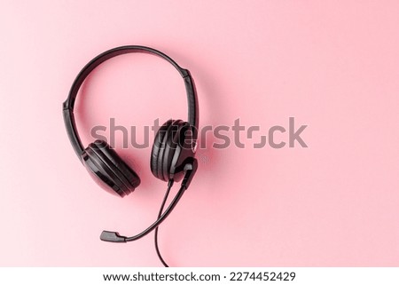 Overheadshot of headset on background with copyspace. Call center concept