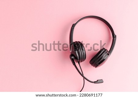 Overheadshot of headset on background with copyspace. Call center concept