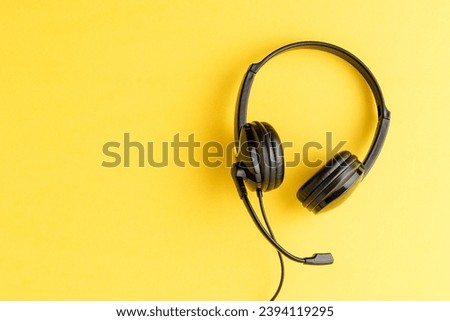 Overheadshot of headset on background with copyspace. Call center concept