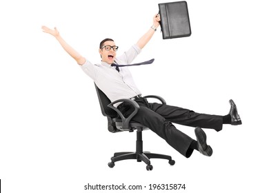 Overjoyed Businessman Riding In An Office Chair Isolated On White Background